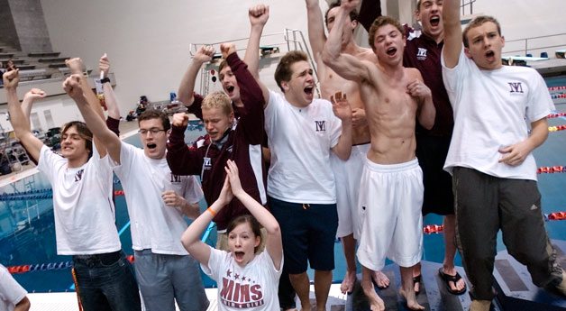 Islander teammates and fans cheer on a victory in state record time in the boys 400-yard freestyle relay event during the 3A state swim championship at the King County Aquatic Center in Federal Way on Saturday. Mercer Island also took the team title with a record 475 total points.