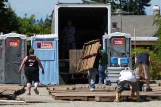 Tent City 4 residents and volunteers set up camp in the Mercer Island United Methodist Church parking lot on Tuesday