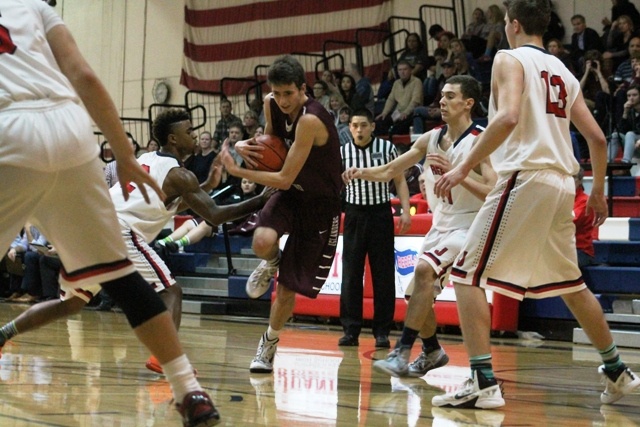 Mercer Island's Sam Nordale fights his way into the paint through the Juanita defense Friday