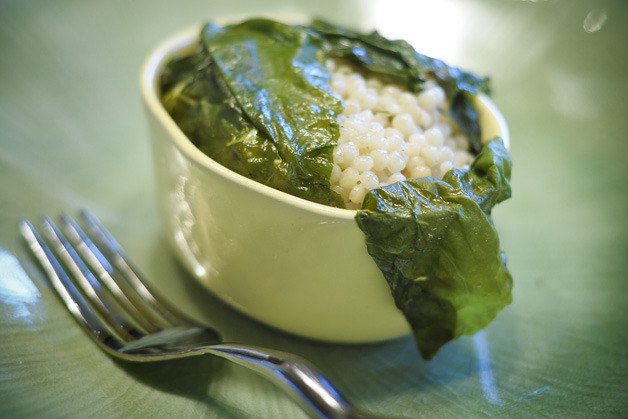 Israeli couscous with herbs packed inside Swiss chard leaves