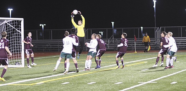 Mercer Island goalie Sam Miller makes a flying catching during the Islanders game against Skyline last Friday night. The Islanders won in overtime 2-1.