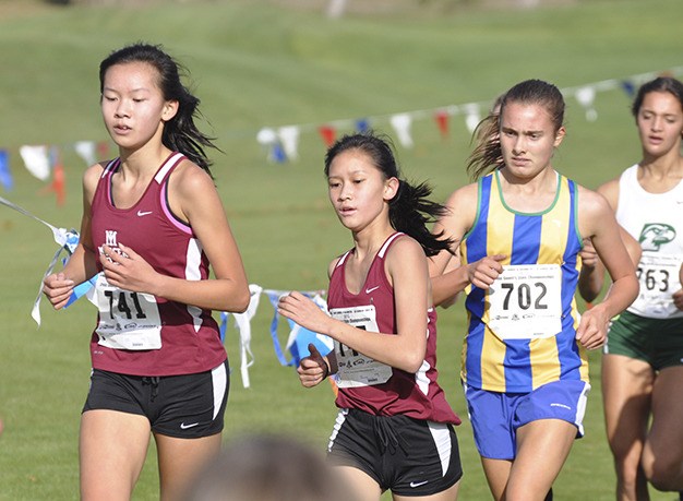 Mercer Island’s Kayla Lee (far left) and Mary Rose Vu compete in the girls 5K at the 3A state cross country championships Saturday
