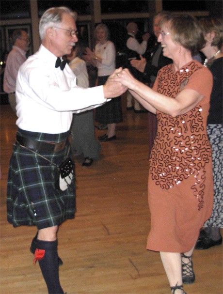 West Seattle couple Will and Cam Winter dance a slip-step down the middle of the set during the Scottish Burns Night Celebration at the Congregational Church on Mercer Island