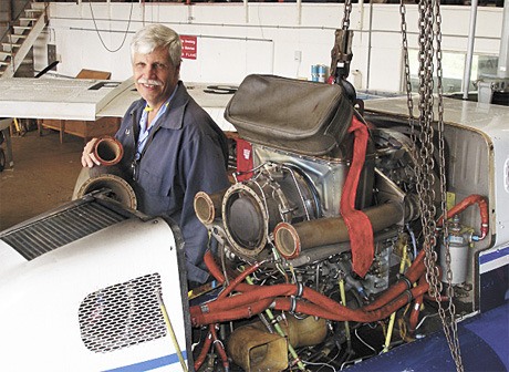 Lloyd Marsden works on a helicopter engine in Ukarumpa