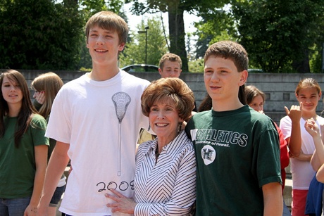 Mercer Island High School teacher Jan Sayers center stands with two of her students