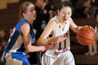 Islander guard Jae Shin (11) drives past a Liberty defender at Mercer Island Friday. The Islanders won 65-58.