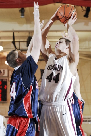 Islander Thomas Ehlers is fouled while attempting to shoot against Juanita.