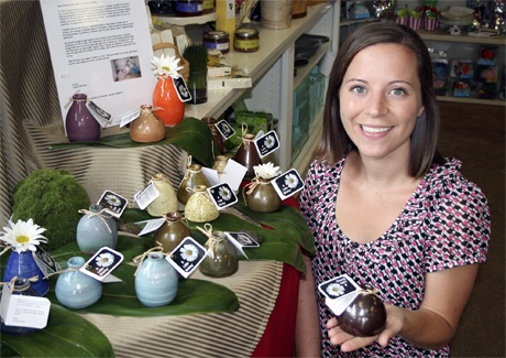 Lauren Burman shows off one of her ceramic flower vases