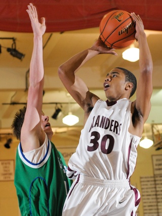 Islander guard Sloan Aikens (30) takes a jump shot against Liberty at Mercer Island on Friday.