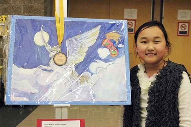 Island Park fourth-grader Jiaxin Luo shows off her artwork