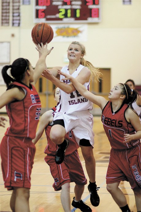 Heidi Black (12) heads for the basket during the Islanders’ win over Juanita last Tuesday.