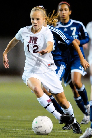 Islanders midfielder Rachel Pedreira (12) advances a ball against Interlake at Mercer Island Tuesday.