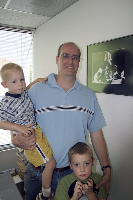Former Reporter Sports Editor Ethan Fowler stands with his two sons