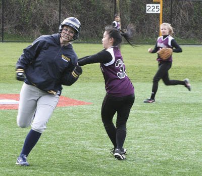 Bellevue's Corri McAllister is tagged out on her way to third base by Mercer Island's Patty Chew during the Islanders home loss against the Wolverines on Tuesday.