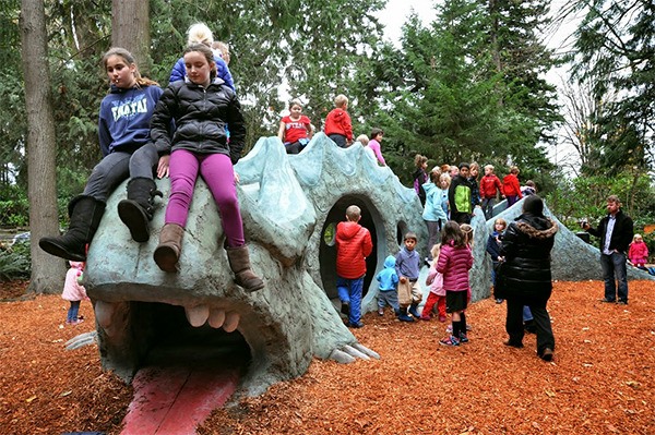 Children celebrate the re-opening of the Kenton’s Dragon sculpture in November 2013.