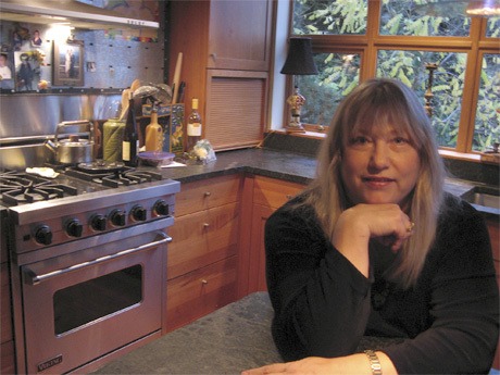 Lynn Michael poses in her kitchen on Mercer Island