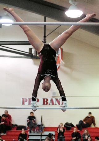 Islander freshman Kristin Trumble competes at the district gymnastics meet on bars. Mercer Island as a team missed the cut for state