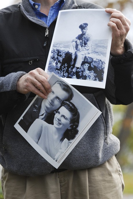 Hank Halle holds photos of his parents