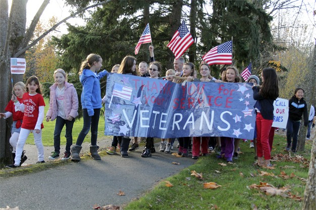 West Mercer Elementary kids parade along S.E. 40th Street with Principal Rich Mellish in honor of troops and veterans on Thursday