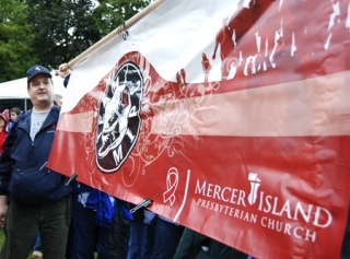 Rich Redman holds the MIPC banner during last Saturday's Seattle AIDS Walk.