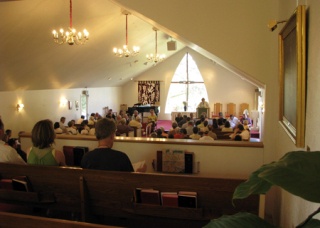 First Hill residents and members of Tent City 4 listen to Rev. Leslie Ann Knight speak from the pulpit during a neighborhood information meeting at the United Methodist Church Wednesday night.