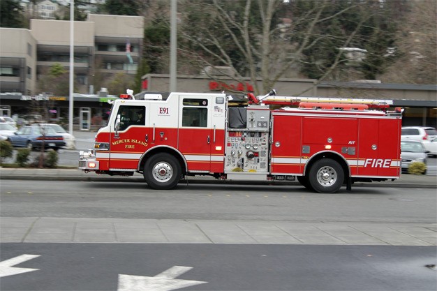 A Mercer Island fire truck roars out of the North end fire station on 78th Avenue S.E.
