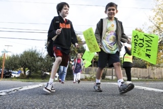 West Mercer Elementary students cross SE 40th St at Homestead Field during International Walk To School Day last Wednesday