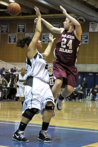 Islander forward Sarah Taylor delivers a jump pass over a defender against Franklin during Sea-King District tournament play at Bellevue Community College on Saturday.