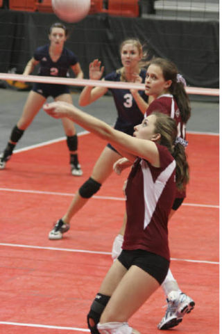 Islander Ariel Dewey digs an offensive hit by an opposing team during the state tournament in Kennewick.