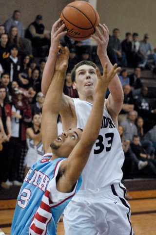 Islander forward Brian Miller (33) grabs an offensive rebound against Chief Sealth during a Sea-King District tournament game at Mercer Island on Tuesday.