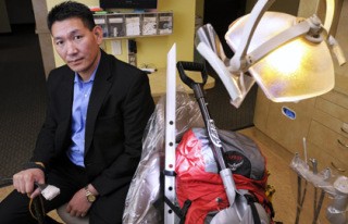 A.C. Sherpa sits with his mountain climbing gear in a dental exam room at Essence of Dentistry Clinic in Redmond on Friday.