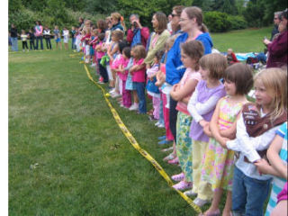 Mercer Island Girl Scouts join hands with parents and other scouts from South Bellevue for an annual awards picnic