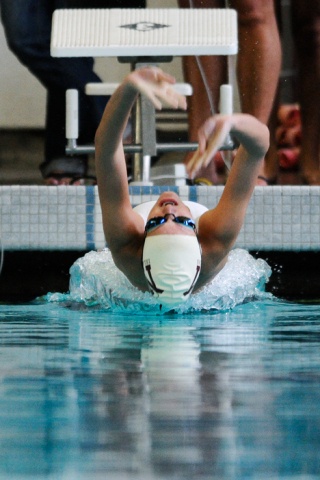 Islanders Emma Nelson starts the back stroke leg of the 200-yard medley relay event against Woodinville at Mary Wayte Pool on Mercer Island Thursday.