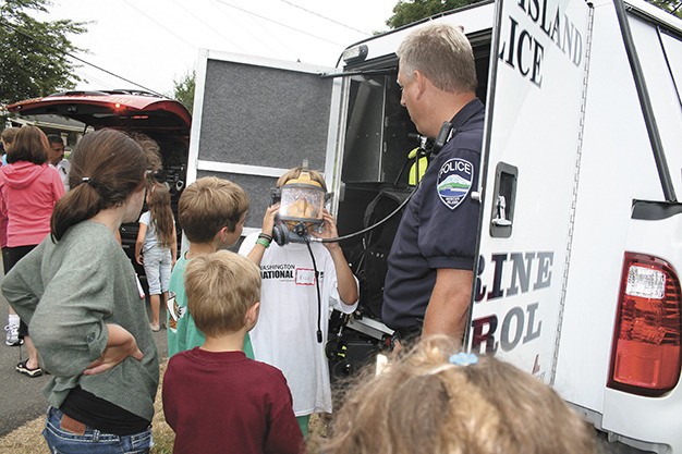Kids try on a Marine Patrol mask during last year’s National Night Out activities on Mercer Island.
