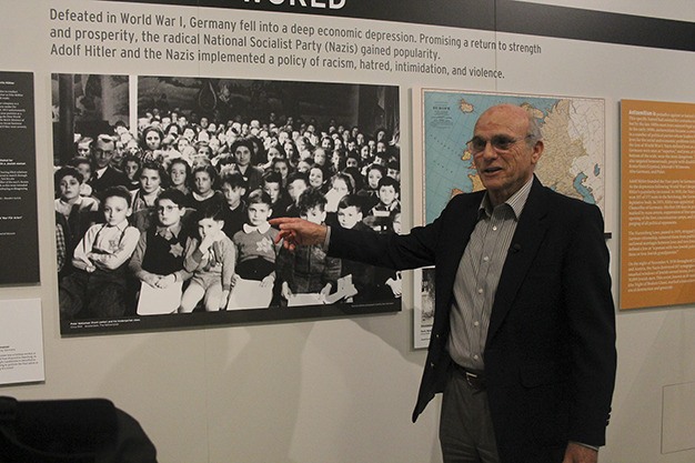 Holocaust survivor Peter Metzelaar points himself out in a photo of child survivors of the Holocaust.