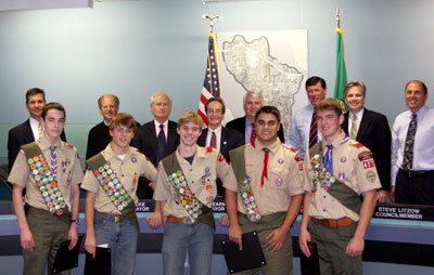 Five Islander Eagle Scouts stand with members of the City Council. The boys were honored for earning their Eagle Scout titles this year.