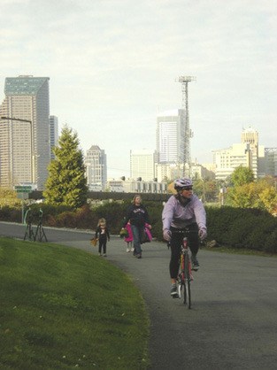 Walkers and riders take advantage of the view of downtown Seattle from the new link to the I-90 trail that extends to Beacon Hill. The new trail was dedicated last weekend.