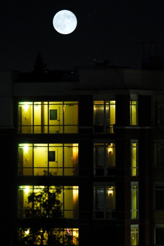 The Mercer is illuminated under a full moon in the downtown business district of Mercer Island Thursday