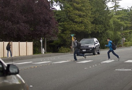 Students sprint across the crosswalk at Island Crest Way and S.E. 42nd Street