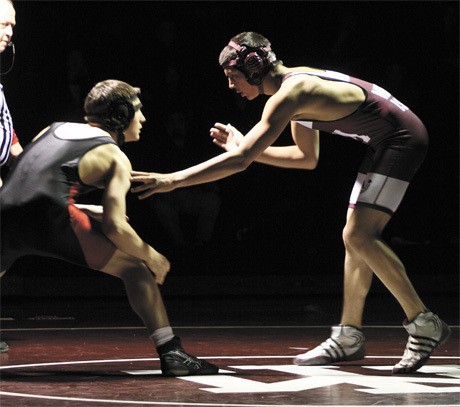 Mercer Island’s Peter Lee looks for a way to take down his Ballard opponent during the Islanders’ wrestling home win over Ballard last Thursday.