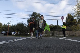 Students make their way across a busy street to school