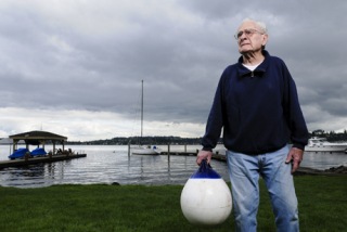 Islander Hu Riley stands with a buoy in his back yard. Riley lives in the same house that he was born in.