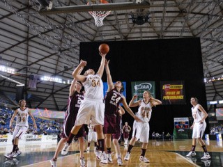Islanders Kate DaPron and Sara Taylor go for a rebound against Prairie at the Tacoma Dome during the state tournament. Below