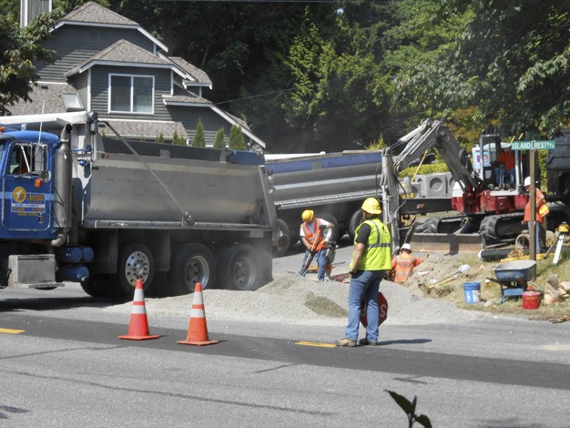 Construction crews work on restructuring Island Crest Way. The road will go from two lanes going north to three lanes with a center turn lane along the middle of the road. Backups from the north to south end of the Island have been reported.