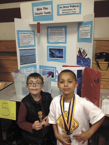 Lakeridge kindergarten students Drew Pollock and Hank Thomas in front of Pollock’s science fair project about how the Titanic sunk.