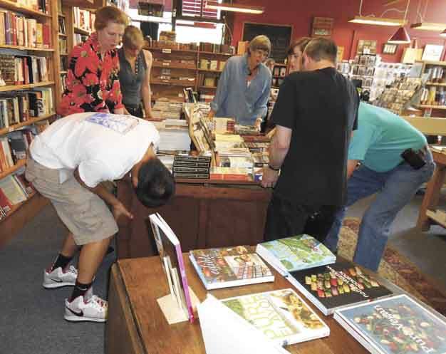 Volunteers at Island Books replace displays on the new carpet. The project was finished the first weekend in July.