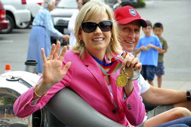 Mary Wayte Bradburne shows off her Olympic medals during the 2012 Summer Celebration Grand Parade on Saturday. This year’s theme was 'Spirit of the Olympics.'