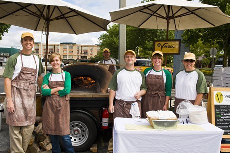 Staff of Veraci Pizza gather in front of their famous wood-fire pizza oven.