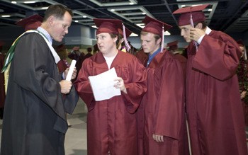 MIHS teacher Chris Twombley consults a final time with class speaker Hap Giraud