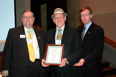 Island citizen Ira Appelman (center) stands with WCOG president Toby Nixon (left) and Attorney General Rob McKenna (right) after receiving the WCOG Key Award.